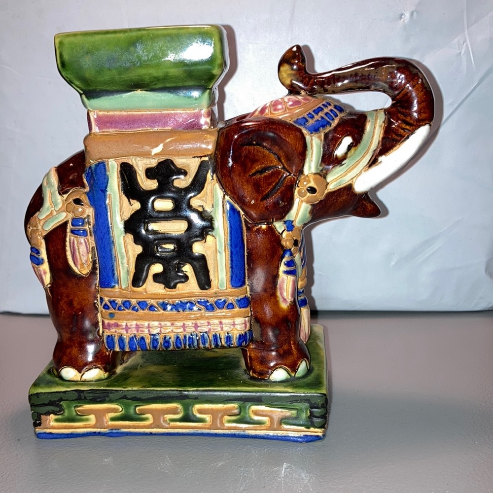 Elephant Figurine Trunk is pointing up. 
Made in South Vietnam